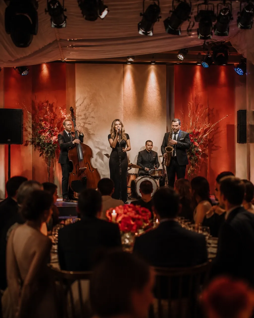 Elegant wedding celebration with a professional stage, warm event lighting, and sound system